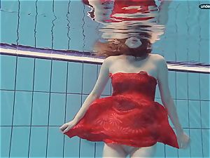 red dressed nubile swimming with her eyes opened